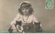 Child - girl petting two cats