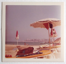 Man stands head, lying deckchair, sea - vintage photo snapshot c. 1970