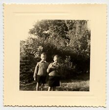 Two children in the garden games - old photo year. 1950