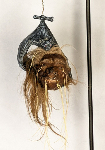 Faux bat shrunken head - &,