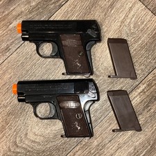 Set Of 2 Colt 25 Cal. Airsoft Spring Powered Pistols + extra magazines