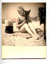 Woman on the beach with fins diving - old photo year. 1950 60