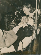 Cecil B. de Mille Directing a Film from a Stretcher, with Barbara Stanwyck, 1