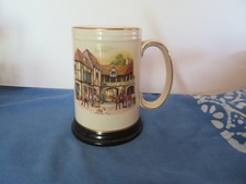 old ceramic beer mug and music box underneath
