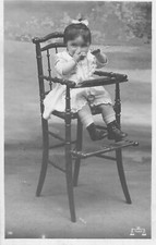 CP ICEE LITTLE GIRL IN HIGH HAND CHAIR WITH SPOON