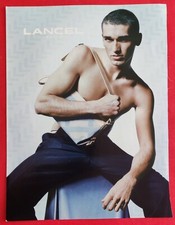 Press advertisement: Luggage bag LANCEL Paris presented by man, gay 2004