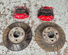 COSWORTH 2WD 4 POT FRONT CALIPERS COMPLETE WITH USED GROOVED DISCS