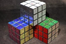 THREE RUBIK'S CUBE 3x3x3 PUZZLES - (2) SPARKLY AND BLACK & WHITE with stands