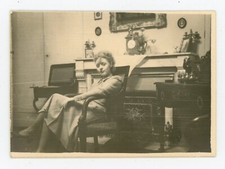 PHOTO snapshot, a woman sitting in skirt fireplace clock painting furniture