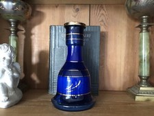 Blue glass carafe with gold stripes