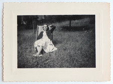 Woman lying deckchair garden smiling nap - vintage photo snapshot c. 1960