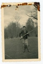 PHOTO SNAPSHOT, a boy poses with a rifle hunting forest countryside