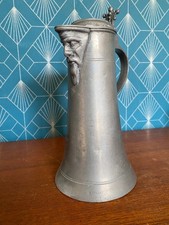 Pewter mug, 18th century, with one face decorations, coat of arms present. Rare.