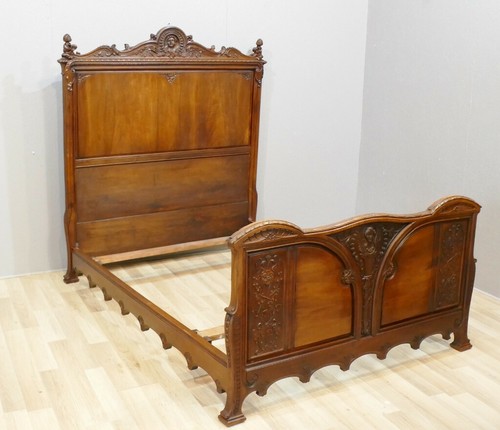 Walnut bed carved with