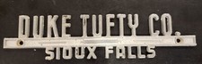 Duke Tufty Co.--Sioux Falls--Metal Dealer Emblem Car  vintage SM5205A