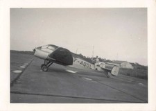 OLD PHOTOGRAPH A MAN POSES ON THE TAIL OF AN ANTIQUE PLANE