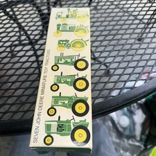 Seven John Deere Miniature Toy Tractors