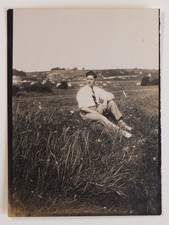 Man poses grass shirt tie landscape - old photo snapshot, small