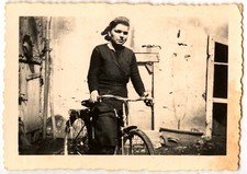Woman cycling in front of house - old photo year. 1930 40