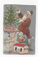 Santa Claus in red dress. Santa Claus decorates the Christmas tree