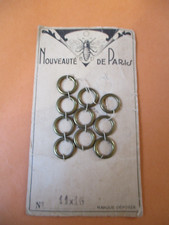 10 Antique Brass Windbreaker Curtain Rings on Carton Comic Book