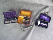 Lot of three antique handheld razors in a box.