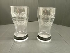 2 Coca Cola collector glasses of the London 2012 Olympics, with its elastic band,...