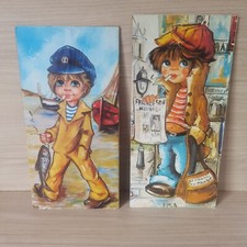 Lot de 2 affiches Poulbot, le titi parisien, pêcheur et marchand de journaux