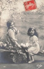 CP BLACK WHITE LITTLE GIRL BASKET EGGS AND BOY ON SWING - 41644