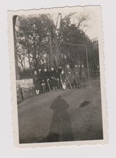 old photo ?️ civilians and military in front of large grille 1940