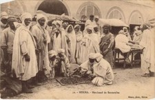 Old postcard AK ALGERIA BISKRA Merchant of Sauterelles (1145744)