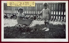 old photo.Life scene.Girl with toys. antique doll land. 1935