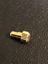 1 poussoir plaqué or chassé