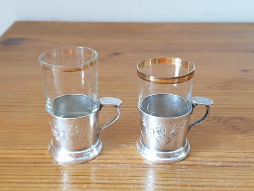 Two small gold trim glasses