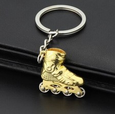 Porte-clés, bijou de sac roller skate, patin a roulette en acier doré chromé.