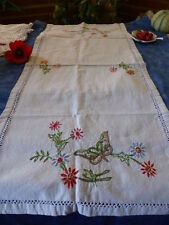 old métis, t good condition, discarded embroidered table or furniture protector + garden plants