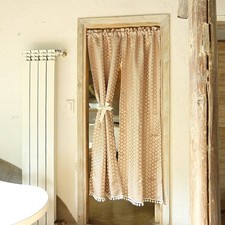 Rideau ancien à motif géométrique avec bordure à pompons pour porte