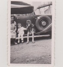 OLD PHOTO-GIRL/LITTLE BOY sitting on the foot of an old car