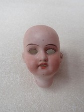 Tête de poupée en porcelaine
