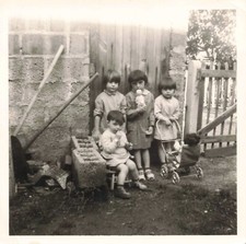 OLD SMALL PHOTOGRAPH FOUR CHILDREN AND THEIR TOYS IN THE GARDEN