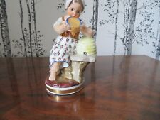 old figurine girl eating honey from her hive