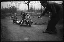 Kids on tricycle men pulling - negative photo old year. 1950