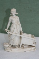 biscuit ancien jeune femme à la brouette.