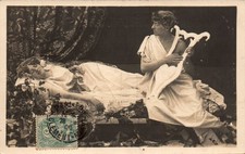 Old postcard - Young woman on a meridian, young man and lyre