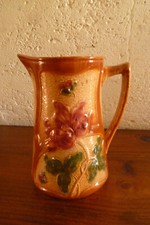 Onnaing light brown pink green sling pitcher? Saint Clement?
