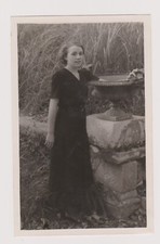 ? Vintage photo woman standing outside near a basin ?