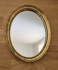 Miroir ovale doré /,décor