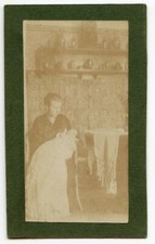 Portrait of young woman with child kitchen - old photo year. 1900