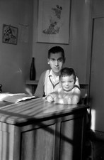 Man at his desk with child - antique photo negative year. 1950