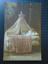 Old postcard 1918 little girl with her doll in bed